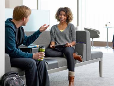 Man and woman talking on Regard couch