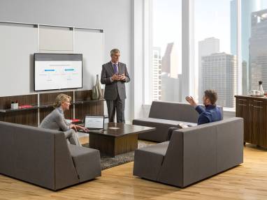 FlexFrame Workwall in convene conference room with three people conversing