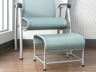 Close-up of a Cura ottoman in front of a Cura Patient Chair