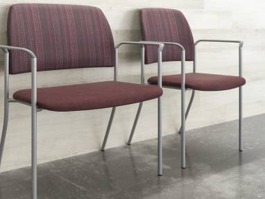 Sorrel Bariatric Stacking Chair next to a Sorrel Stacking Chair against a wall