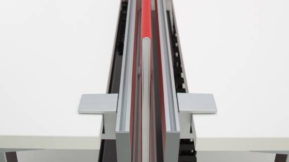 SOTO Rail with a red screen divider in between two white desk surfaces
