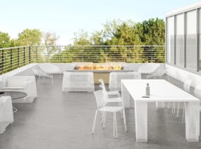Outdoor workcafe with white tables and chairs for meals and gatherings