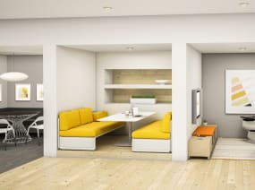 Two separate lounge spaces with yellow Lagunitas sofas and two gray Massaud lounge chairs