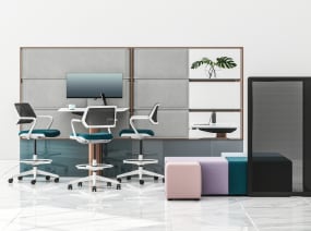 Three Steelcase Qivi stools around a Mackinac worksurface with B-Free cubes and Screen pictured next to it
