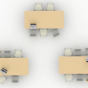 High view of 3 wooden tables with chairs around them