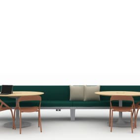 Rendering of a large green sofa and two rounded tables with chairs