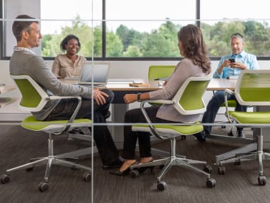 People sitting on QiVi Collaborative Chairs in a conference room