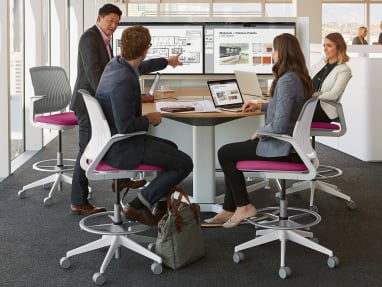 Four employees collaborating in front of a media:scape
