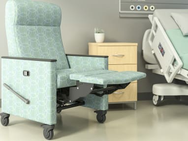 Green Mineral Recliner with footrest extended in front of a hospital bed