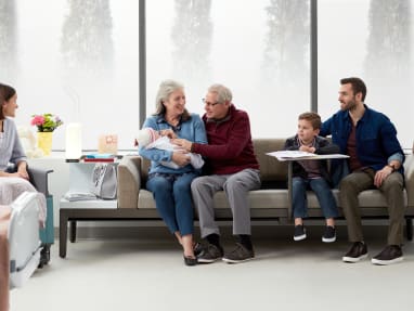 A family uses a Surround lounge system from Steelcase in a healthcare setting