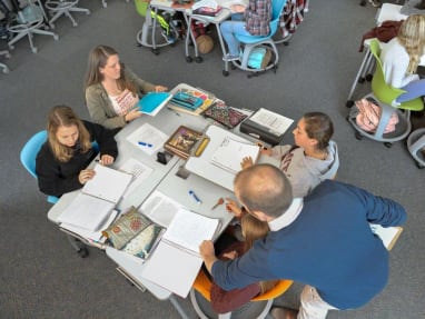 An overhead view of students working together while using Verb Active tables and Node tripod base chairs