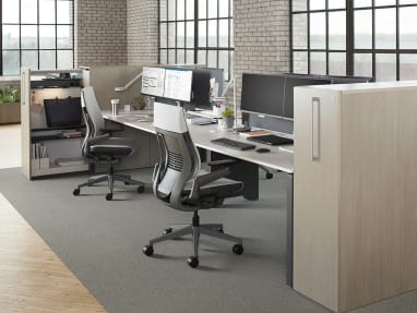 A workstation is created by using a FrameOne Resident Bench from Steelcase with high density storage and two Gesture desk chairs