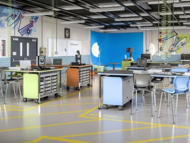 Education space with a variety of colorful products, that include chairs, desks and storage cabinets.