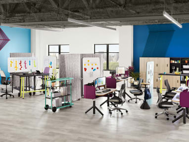 An office environment that includes Steelcase Flex height-adjustable desks, Gesture desk chairs, Flex Slim tables, SILQ stool height chairs, and Steelcase Flex carts