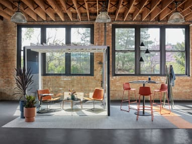 Enea Lottus bar-height stools are shown next to a Montara650 table beside an Orangebox Air23 pod with West Elm Slope Lounge Chairs and a Bolia Mix coffee table