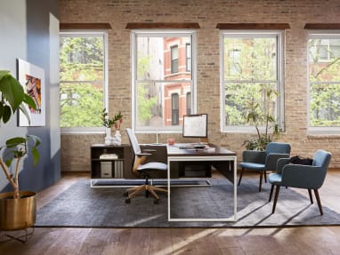 Private office with West Elm Greenpoint private office desk, two Bolia C3 chairs, and a SILQ desk chair