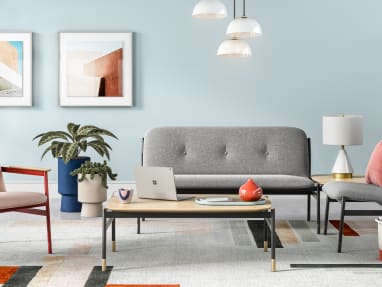 A lounge setting featuring West Elm Work products, including Brighton Chair, Brighton two seat and single seat seating, and a coffee table