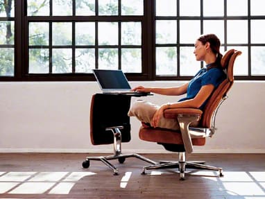 Woman seating in a Leap chair with her laptop