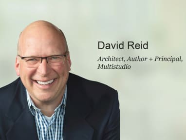 david reid front picture wearing a suit and glasses