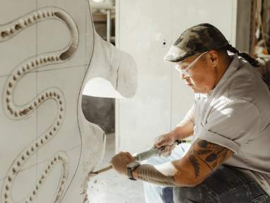 Man building an art piece