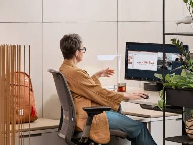 Woman working in an office on an individual desk