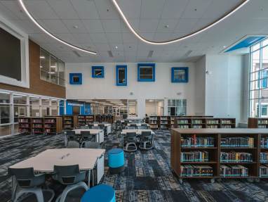 Classroom with book shelves, tables and chairs