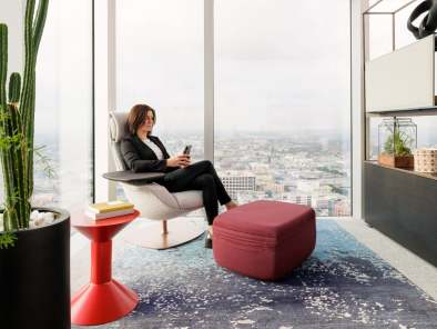 Woman sitting on a lounge chair.