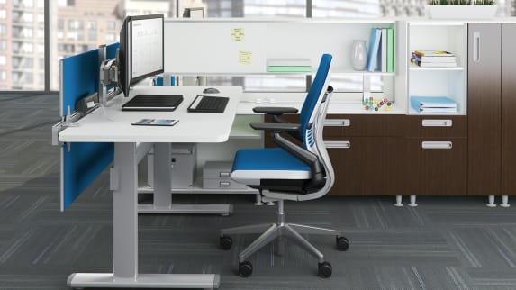 Blue Gesture chair and white Series 7 Height-Adjustable Desk with double monitor.