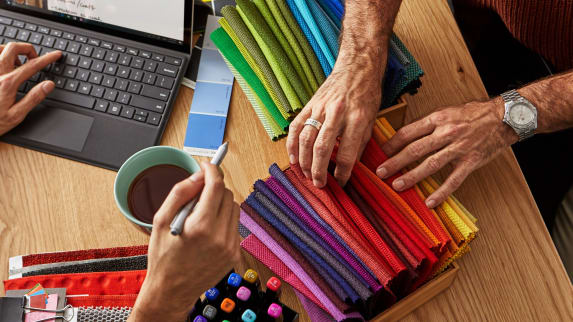 team members collaborating over colorful materials palettes