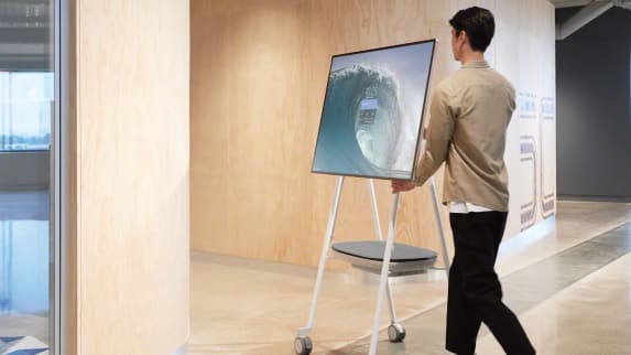 Man moves a Steelcase Roam Mobile Stand