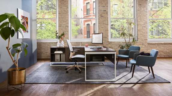 Private office with West Elm Greenpoint private office desk, two Bolia C3 chairs, and a SILQ desk chair