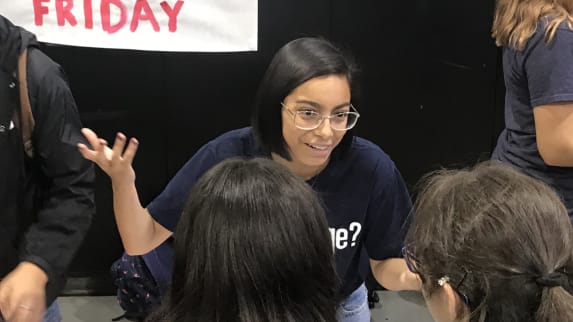 Valeria wearing glasses and talking to girls