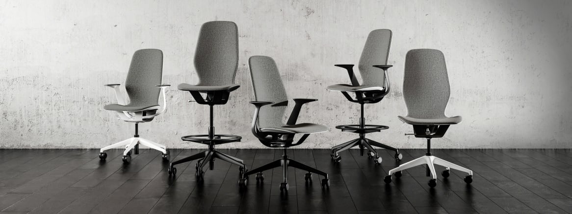 5 gray SILQ chairs with black and white bases arranged next to each other.