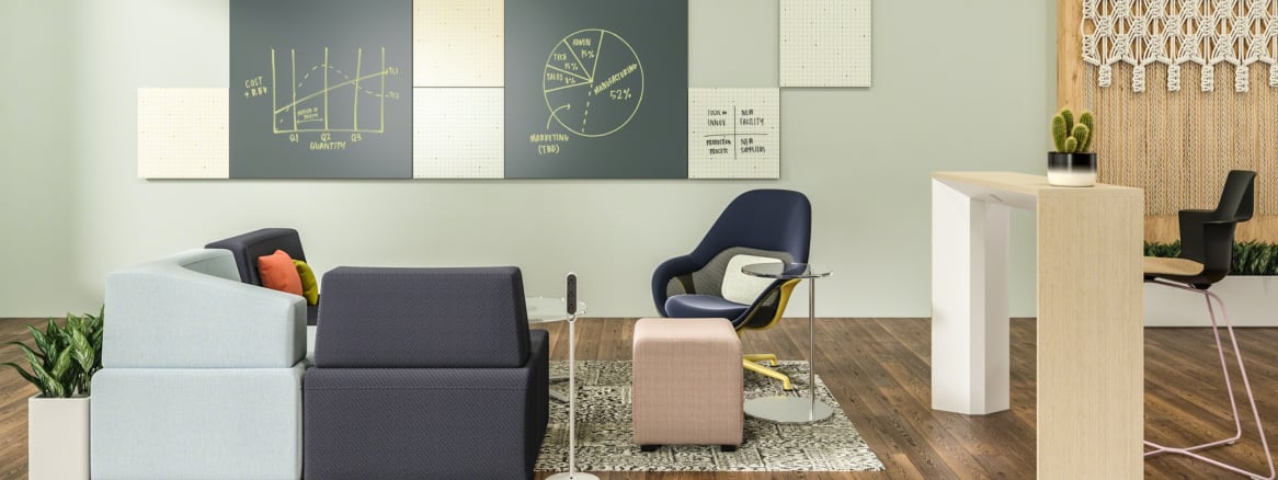 A Motif Collaborative Panel System from PolyVision hangs on the wall by an office lounge area that features SW_1 lounge seating from Coalesse, Thread portable outlets, a Campfire Slim table, and a Shortcut X base stool