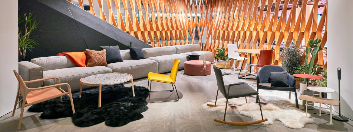 A selection of Steelcase products are showcased in a lounge-style setting during NeoCon 2018, including a Carl Hansen PK1 chair, a Montara650 rocker, Montara650 lounge chair, and Bob occasional table