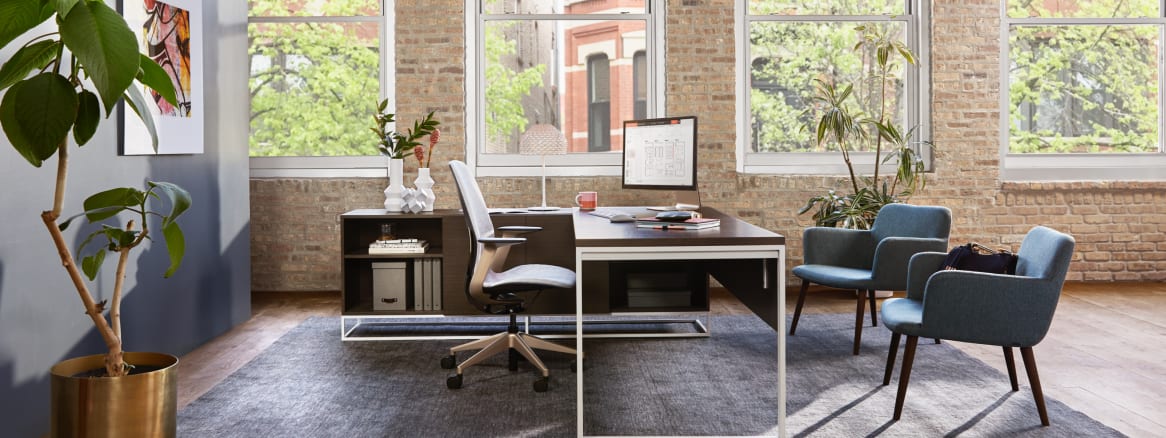 Private office with West Elm Greenpoint private office desk, two Bolia C3 chairs, and a SILQ desk chair