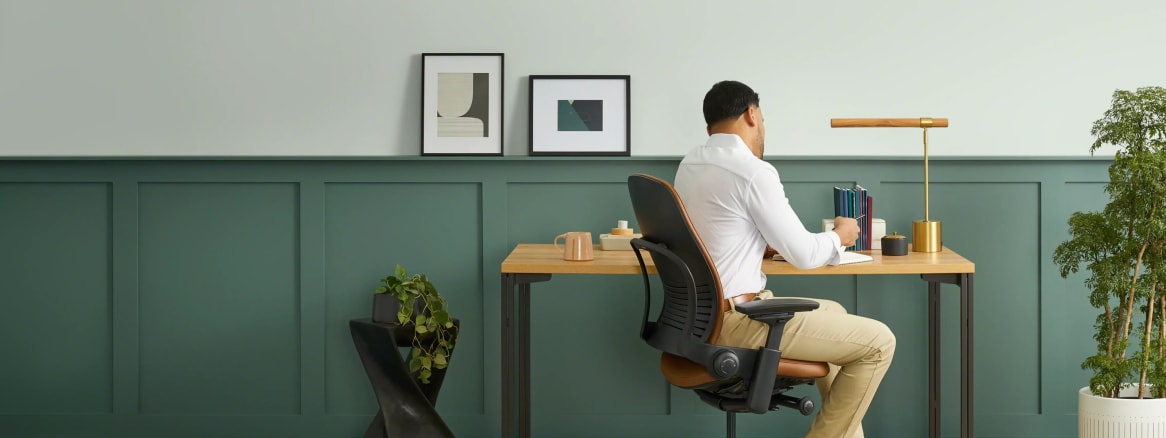 Man sitting in a chair and working at his desk