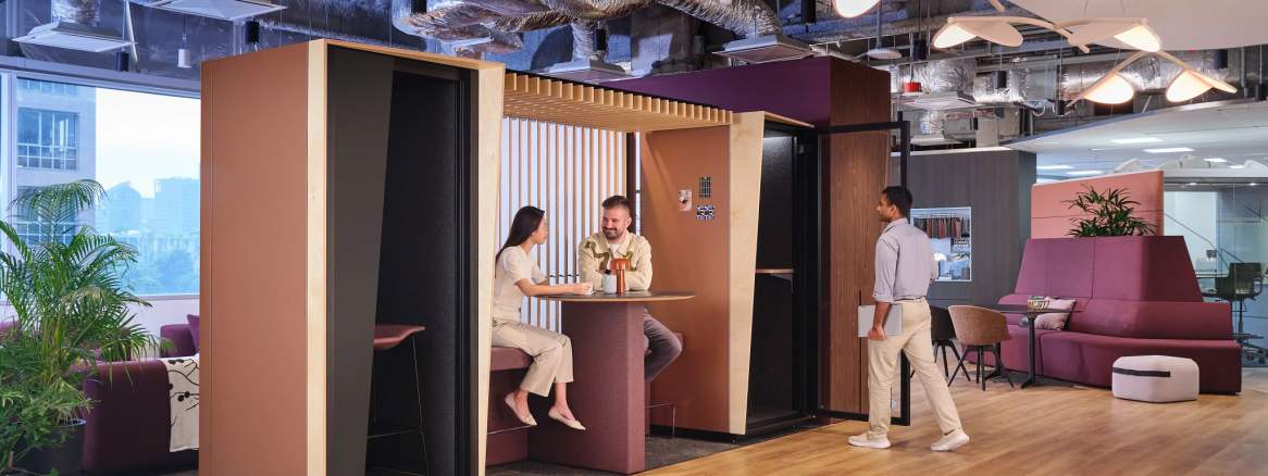 Orangebox Be my guest® phone booth with canopy and wall in an office environment