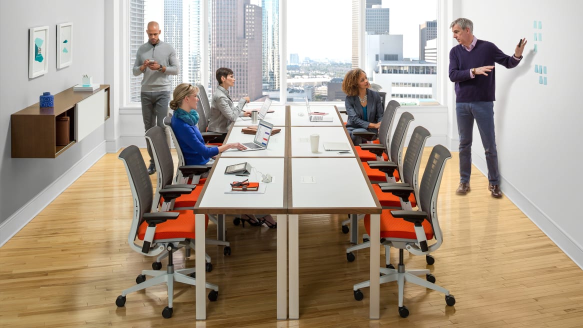 people at a meeting sitting in Think office chair