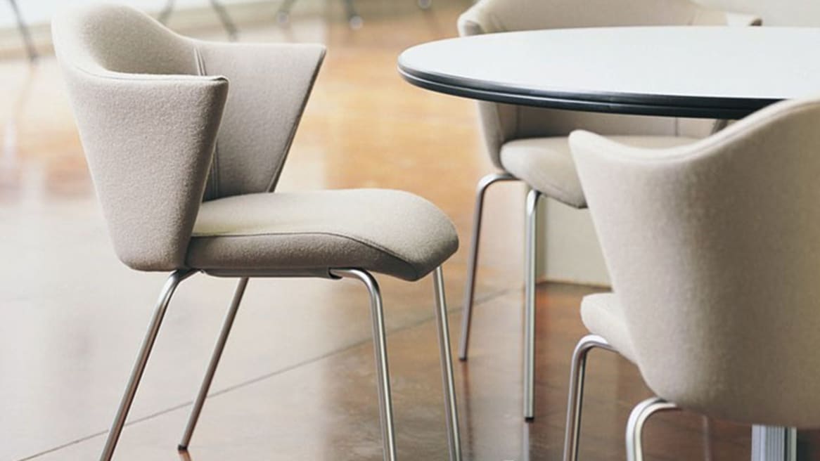 Three Capa Stackable Chairs around a round table