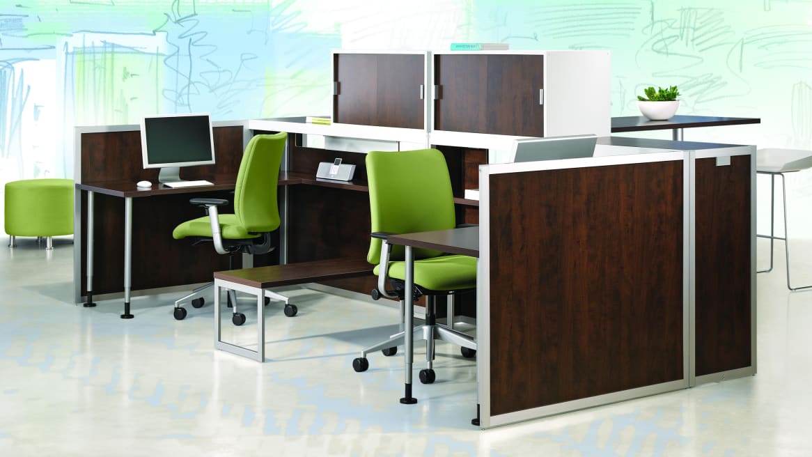 Two Tour Workspaces with dark wood veneer and green chairs