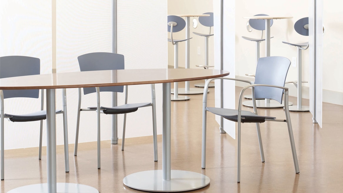 Three Enea Stacking Chairs at a table