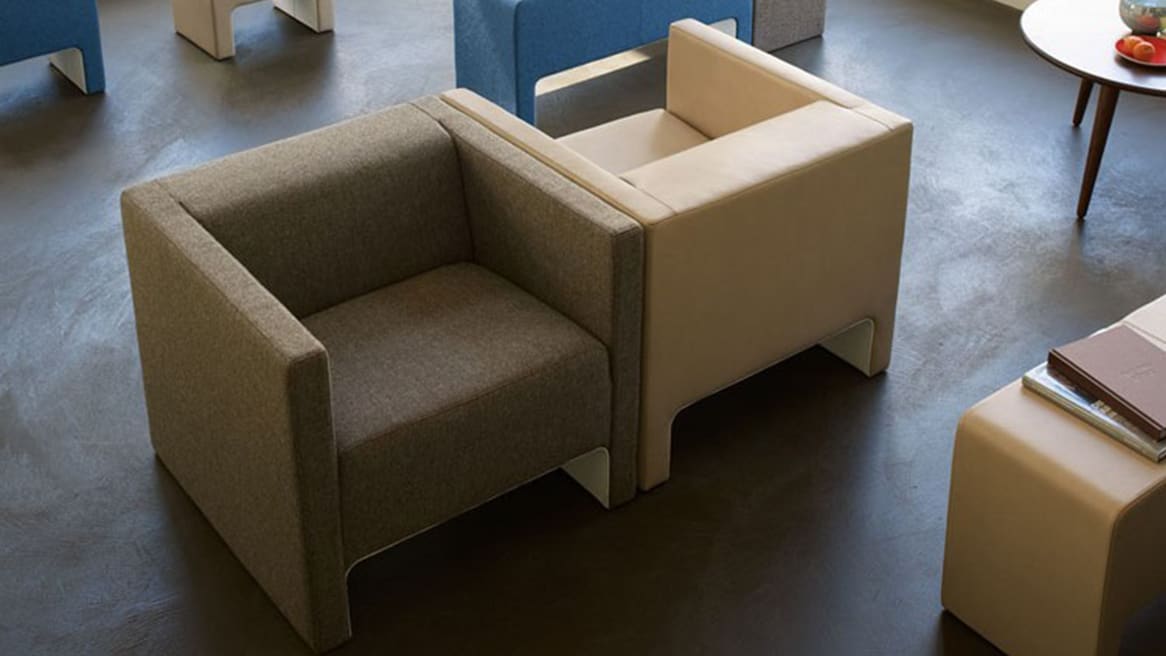 One Brown Davos Lounge Chair and One Tan Davos Lounge Chair side by side facing opposite directions