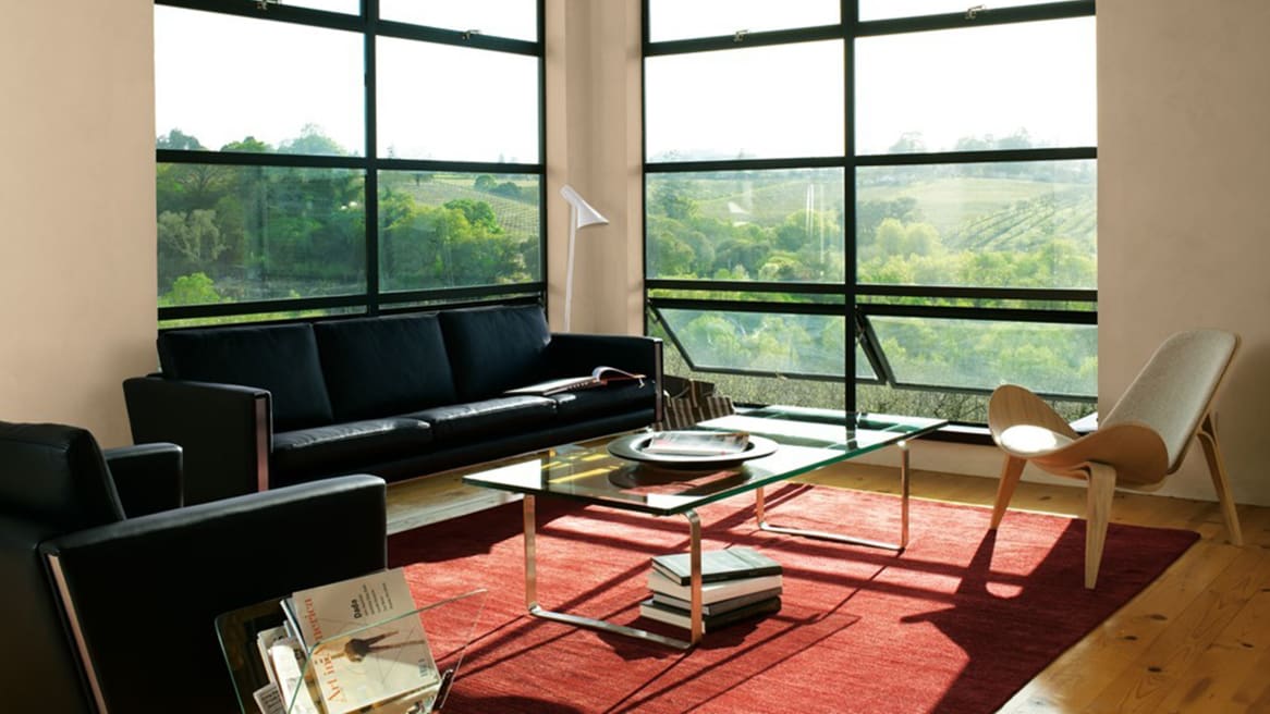Glass Coffee Table CH108 in front of windows in a lounge area