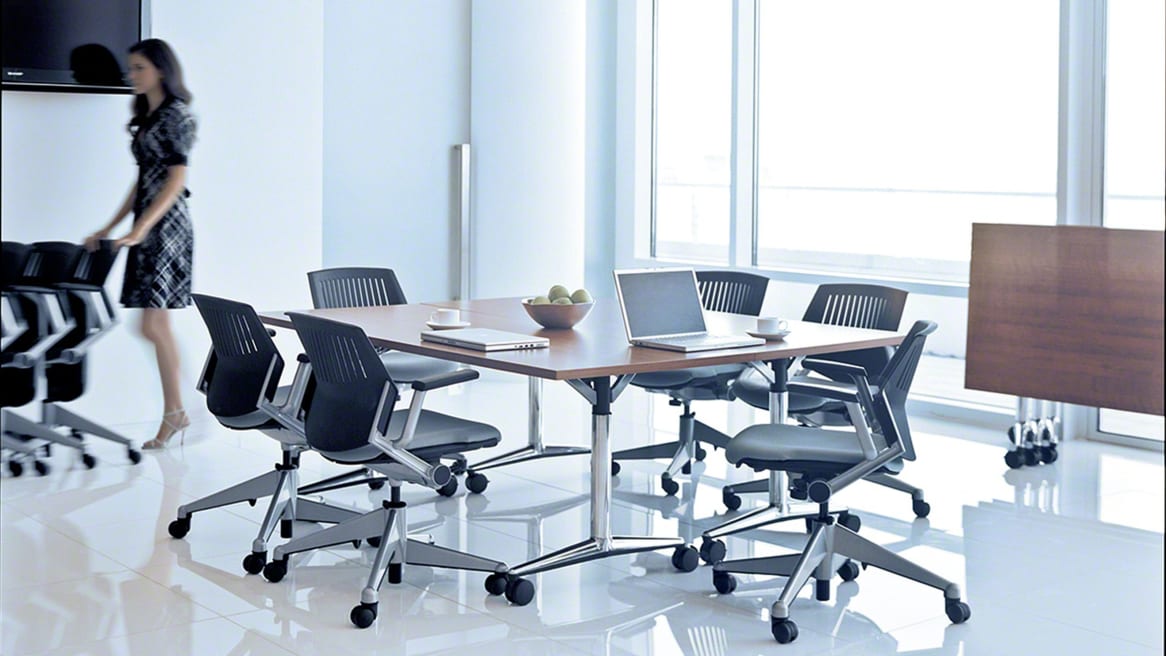 Six Black Kart Nesting Chairs around a conference table