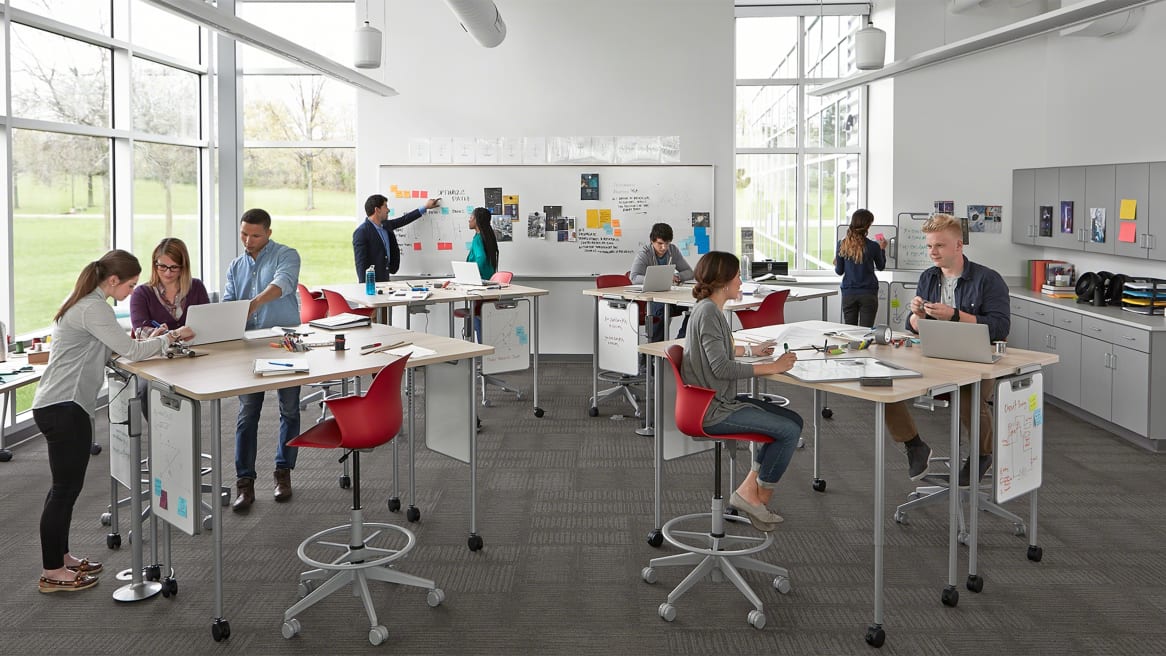 Verb Tables and Whiteboards and red Node Chairs in an active learning classroom setting
