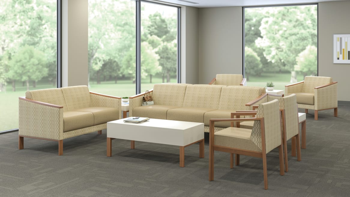 Tan Tava Loveseat, Sofa and Single Chairs around a White Coffee Table in a waiting room