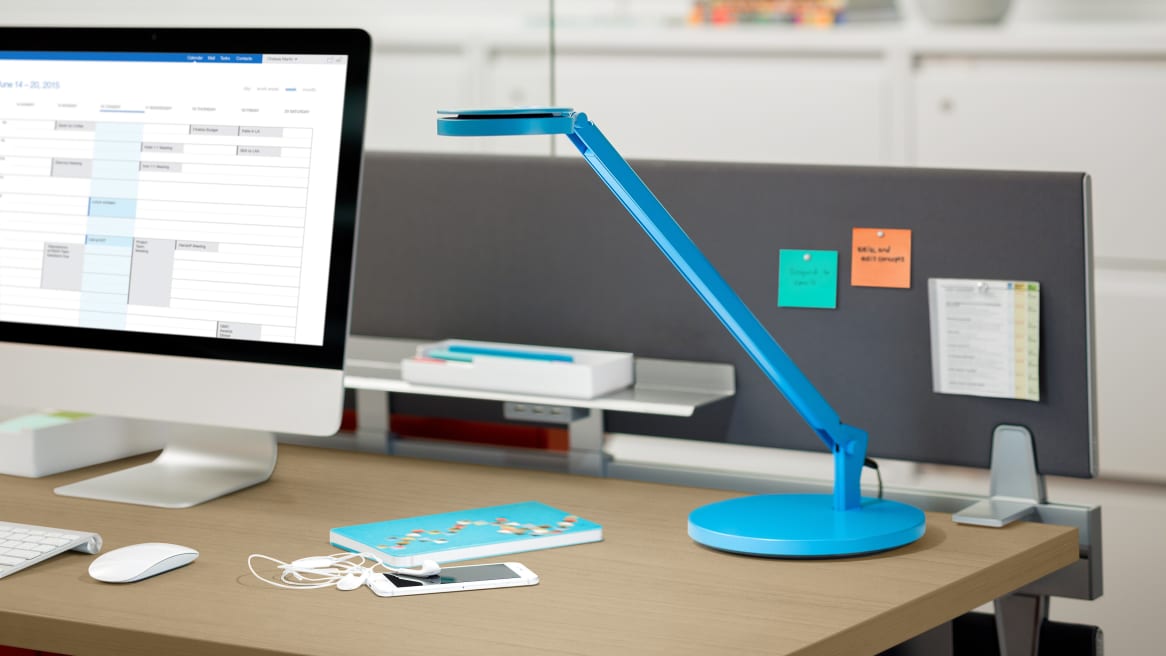 Blue Dash LED Mini Task Light on Desk next to a computer and a cellphone