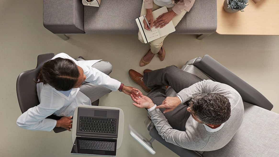 An overhead photo showing three people sitting in Steelcase seating in a healthcare setting