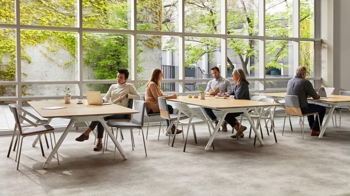 Three Potrero415 tables and LessThanFive and Montara650 chairs are used in a cafe setting by windows